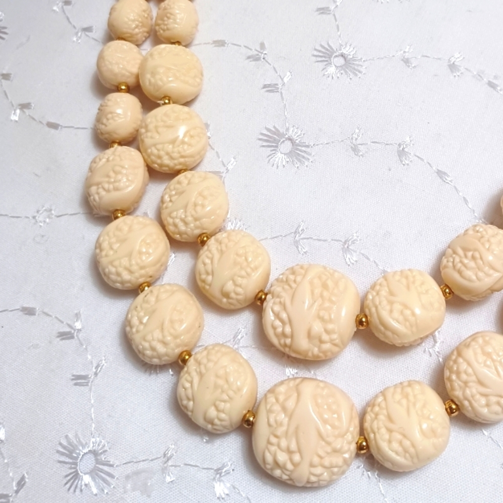 Vintage strand of cream color carved celluliod/acrylic and gold beads